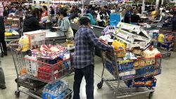 RICHMOND, CALIFORNIA - MARCH 13: A Costco customer stands by his two shopping carts at a Costco store on March 13, 2020 in Richmond, California. Some Americans are stocking up on food, toilet paper, water and other items after the World Health Organization (WHO) declared Coronavirus (COVID-19) a pandemic. (Photo by Justin Sullivan/Getty Images)