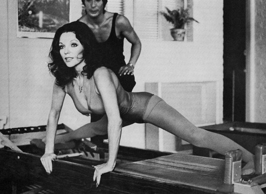 Joan Collins works out with famous Pilates instructor Kim Lee at his exercise studio in Beverly Hills in April 1976.