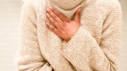 mid adult woman experiences symptom of shortness of breath