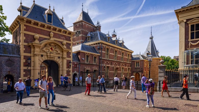 The Hague, Netherlands - July 21, 2019; people walking on Binnenhof, centre of Dutch politics, in The Hague with the famous Mauritshuis museum on the right