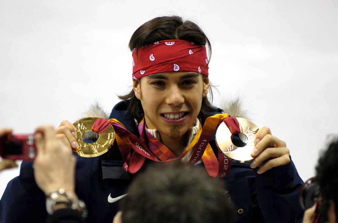 Apolo Ohno of the United States celebrates winning a gold and bronze medal at the 2006 Games in Turin.