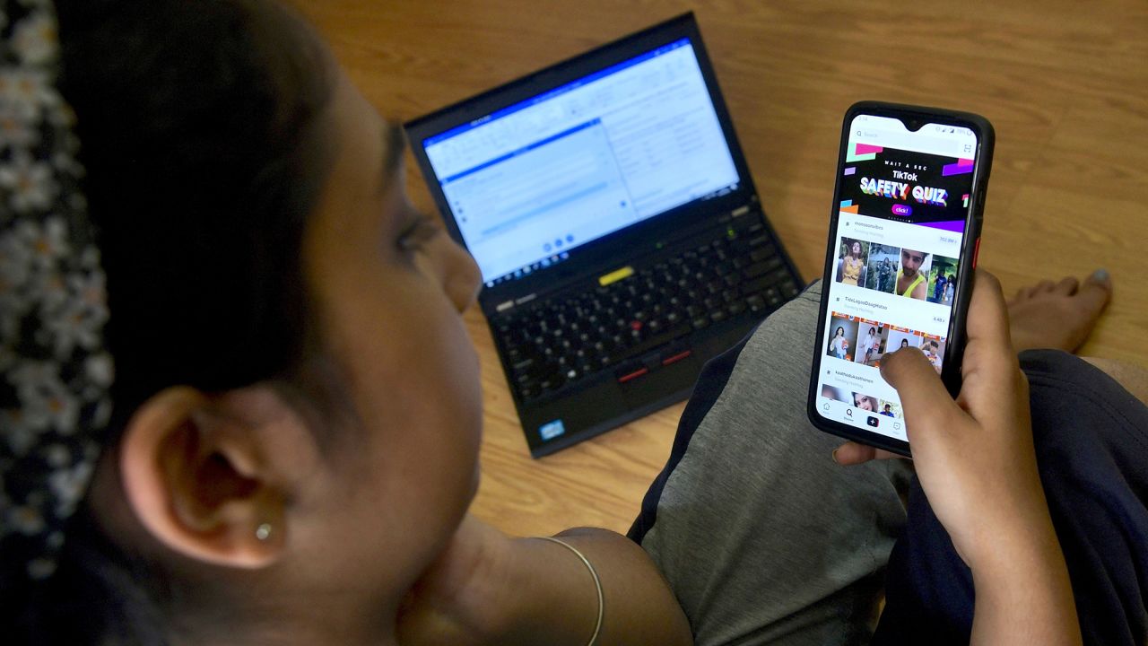 An Indian mobile user browses through the Chinese owned video-sharing 'Tik Tok' app on a smartphone in Bangalore on June 30, 2020. - TikTok on June 30 denied sharing information on Indian users with the Chinese government, after New Delhi banned the wildly popular app citing national security and privacy concerns.
"TikTok continues to comply with all data privacy and security requirements under Indian law and have not shared any information of our users in India with any foreign government, including the Chinese Government," said the company, which is owned by China's ByteDance. (Photo by Manjunath Kiran / AFP) (Photo by MANJUNATH KIRAN/AFP via Getty Images)