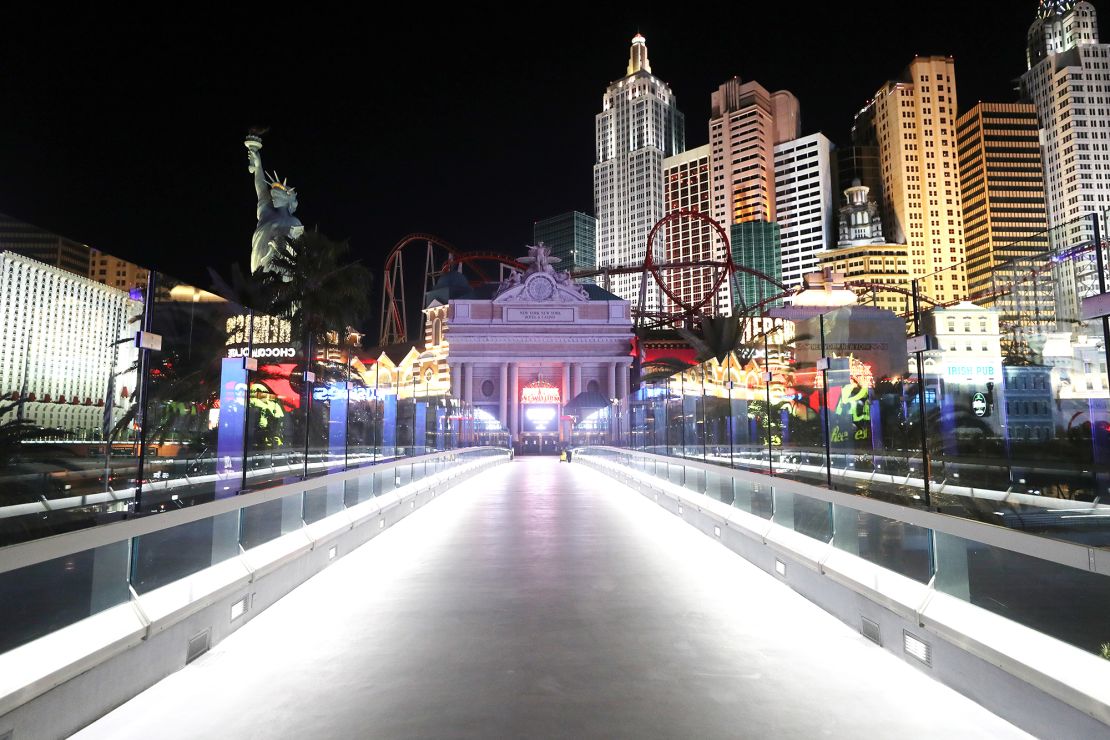 A nearly empty footbridge leads toward New York-New York Hotel & Casino on the Las Vegas Strip, where businesses closed in 2020 in response to the pandemic.
