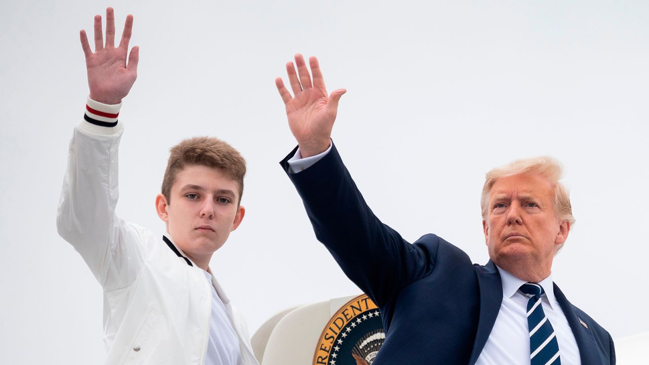 US President Donald Trump and his son Barron wave as they board Air Force One at Morristown Municipal Airport in Morristown, New Jersey, on August 16, 2020.