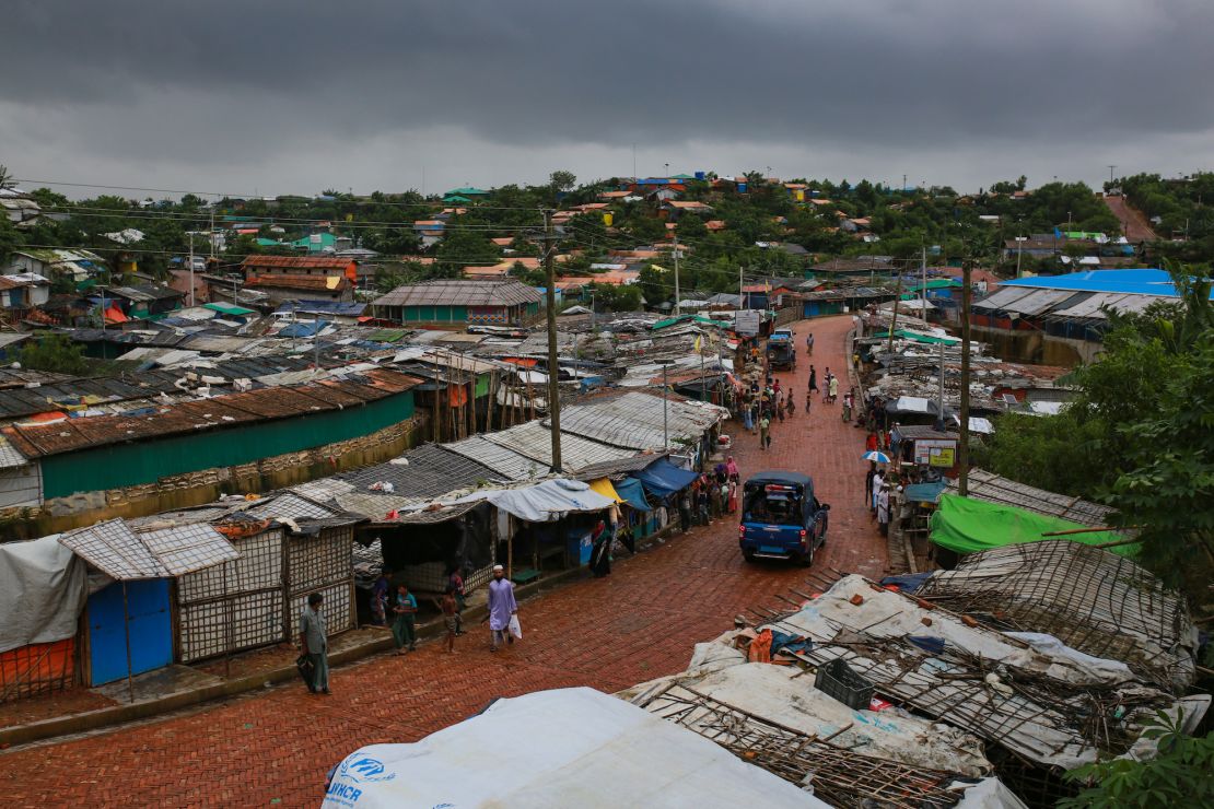 Rohingya refugees walk on road through a closed market at Kutupalong refugee camp in Ukhia, Cox's Bazar, Bangladesh, on August 25, 2020.