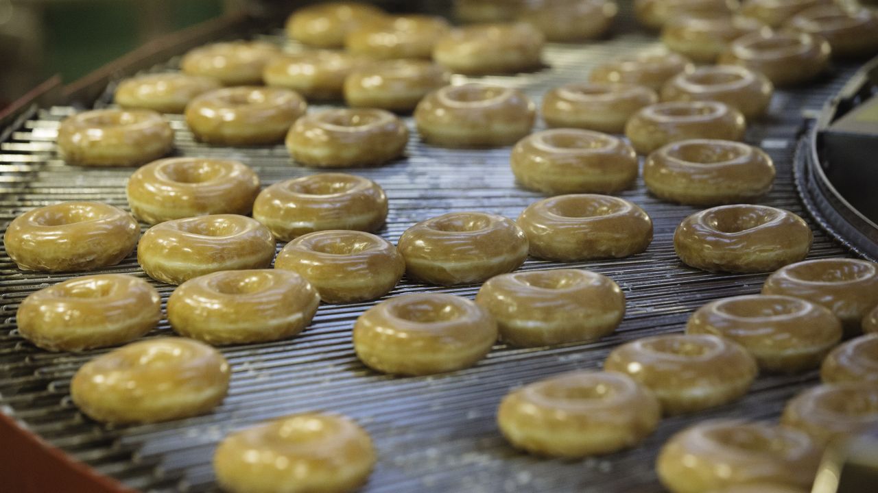 Doughnuts on an production line inside a Krispy Kreme Doughnuts Inc. store in the Times Square neighborhood of New York, U.S., on Thursday, Sept. 10, 2020. The 4,500-square-foot tourist attraction has a glaze waterfall, a 24-hour street-side pickup window, exclusive merchandise and a doughnut-making theater that produces 4,560 doughnuts an hour. Photographer: Angus Mordant/Bloomberg via Getty Images