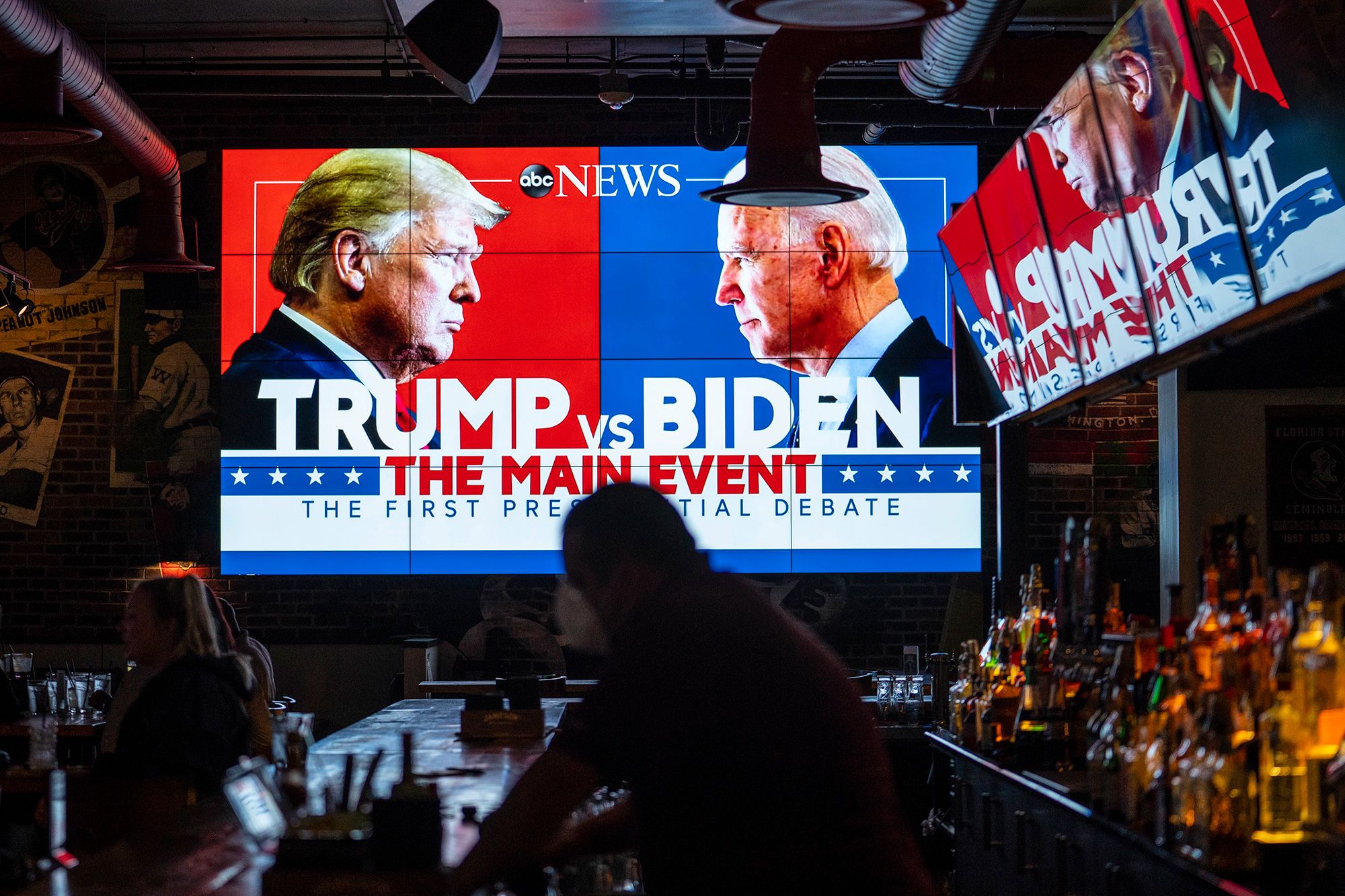 Television screens airing a presidential debate at a sports bar in Washington, DC in 2020.