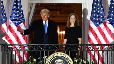 President Donald Trump gestures next to Judge Amy Coney Barrett on the Truman Balcony after she was sworn in as a US Supreme Court Associate Justice during a ceremony on the South Lawn of the White House October 26, 2020, in Washington, DC.