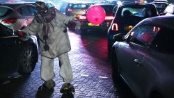 An actor dressed as a character from a horror movie scares people as they park up to watch a horror film at a temporary drive in cinema in Manchester, northwest England on October 29, 2020. (Photo by Paul ELLIS / AFP) (Photo by PAUL ELLIS/AFP via Getty Images)