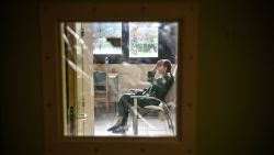 A patient with mental disorders sits on a chair in her room at The Ville-Evrard Psychiatric Hospital in Saint-Denis, north of Paris on November 3, 2020. - After the consequences of the first confinement linked to Covid-19 are just starting to fall as psychiatrists at the mental health establishment of Ville-Evrard, in the Paris suburbs, fear a second "psychiatric wave". (Photo by Christophe ARCHAMBAULT / AFP) (Photo by CHRISTOPHE ARCHAMBAULT/AFP via Getty Images)