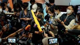 Claudia Mo, pro-democracy lawmaker, holds a yellow umbrella as she is surrounded by members of the media while on her way to submit her resignation letter to the president of the Legislative Council in Hong Kong, China, on Thursday, November 12, 2020.