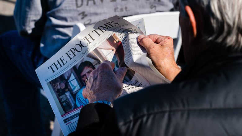 An attendee reads a copy of The Epoch Times newspaper during a Defend The Majority Event in Augusta, Georgia, U.S., on Thursday, Dec. 10, 2020.