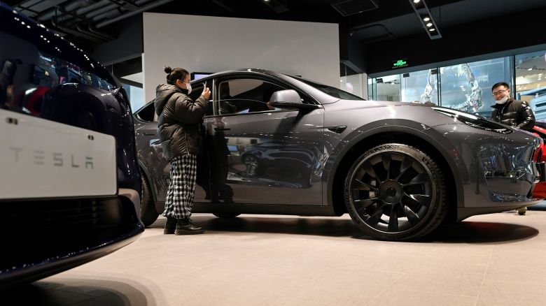 People look at a Tesla Model Y car at a Tesla showroom in Beijing, China on January 5, 2021.