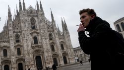 A man smokes a cigarette on Piazza del Duomo in Milan on January 19, 2021 as it became the first Italian city to introduce an outdoor smoking ban following the air quality regulations approved by the Milan City Council. - Milan municipality has declared war on smoking, no cigarettes in the city's public parks, dog areas, cemeteries, playgrounds, sports and recreational areas for children, sports facilities including terraces, and public transport stops, including taxi ranks. The smoking ban is not total, there is an exemption in all these cases, you have to stay at least ten metres away from others. (Photo by Piero CRUCIATTI / AFP) (Photo by PIERO CRUCIATTI/AFP via Getty Images)