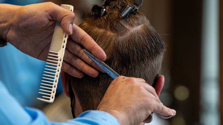A barber cuts a customer's hair at a barber shop in San Francisco, California, U.S., on Thursday, Jan. 28, 2021.