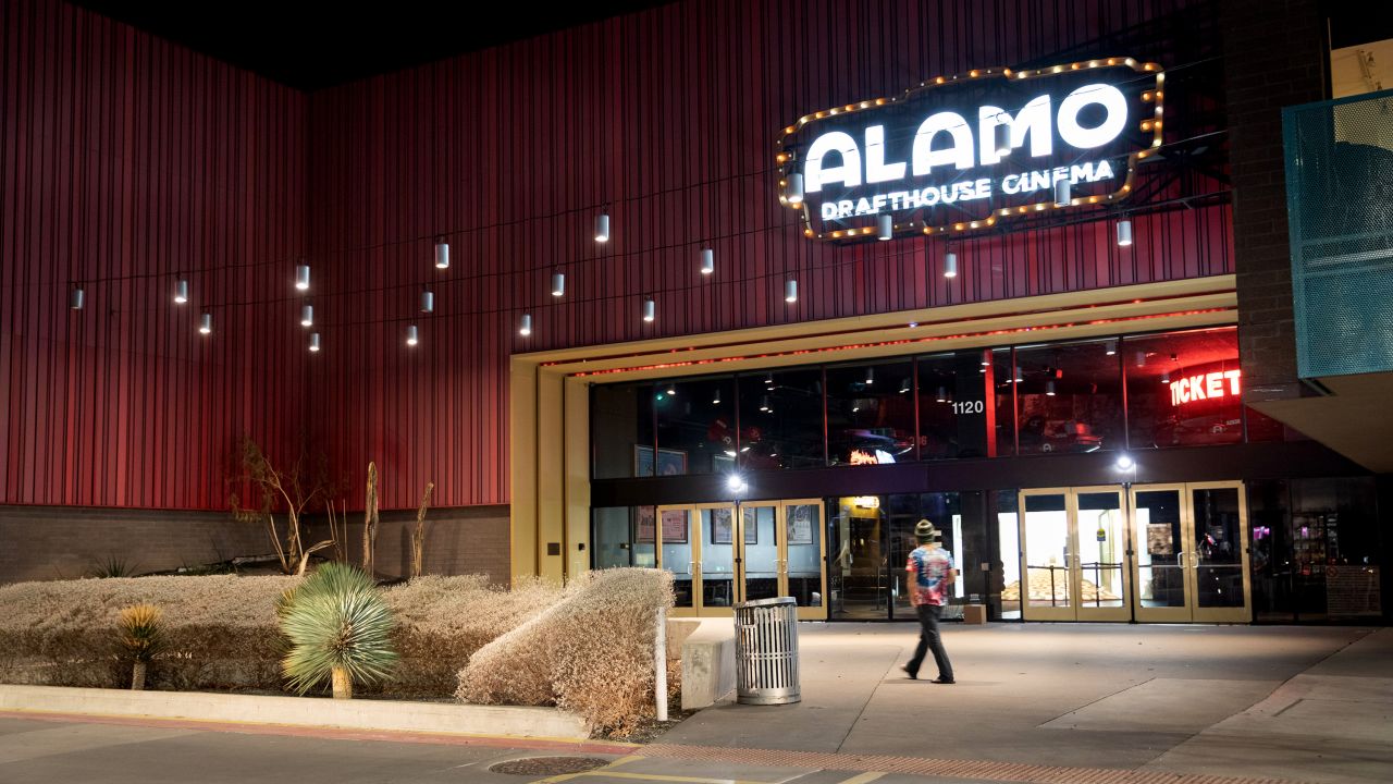 A pedestrian walks past the Alamo Drafthouse South Lamar in Austin, Texas, U.S., on Wednesday, March 3, 2021.