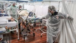 Medical staff members transport a patient on a stretcher at the Pedro DellAntonia Sports Complex field hospital as coronavirus cases soar on March 11, 2021 in Santo Andre, Brazil. The state of Sao Paulo has reached over 80% occupancy in intensive care units and has declared a red alert as the spread of COVID-19 has accelerated in Brazil in recent weeks. State Health Minister Jean Gorinchteyn announced that they are already recruiting health professionals for reinforcement and working in 140 extra ICUs to prevent the collapse of the health system. 38 patients with COVID-19 have already died on the waiting list for ICU's beds in the state in the first ten days of March.
