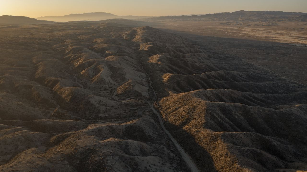 NEW CUYAMA, CA - MARCH 28:  In an aerial view from a drone, the San Andreas Fault and Elkhorn Scarp are seen south of Carrizo Plain on March 28, 2021 north of New Cuyama, California. The San Andreas Fault, long feared for its potential to cause the biggest natural disaster ever in Southern California, is capable of producing and 8.1-magnitude earthquake that could killed thousands of people and cause hundreds of billions of dollars in damage. The southern segment of the fault, extending for hundreds of miles from the Salton Sea in the south, passes as close as 35 miles from Los Angeles, through the Big Bend section in Kern County and on to Parkfield in Monterey County. It is the Big Bend section of the fault that is believed to have become locked, preventing the fault from slipping to release the ever-increasing pressures caused by the grinding of the Pacific and North American tectonic plates. The locked fault is rapidly increasing the risk of the long overdue "Big One" quake that scientists say is inevitable. (Photo by David McNew/Getty Images)