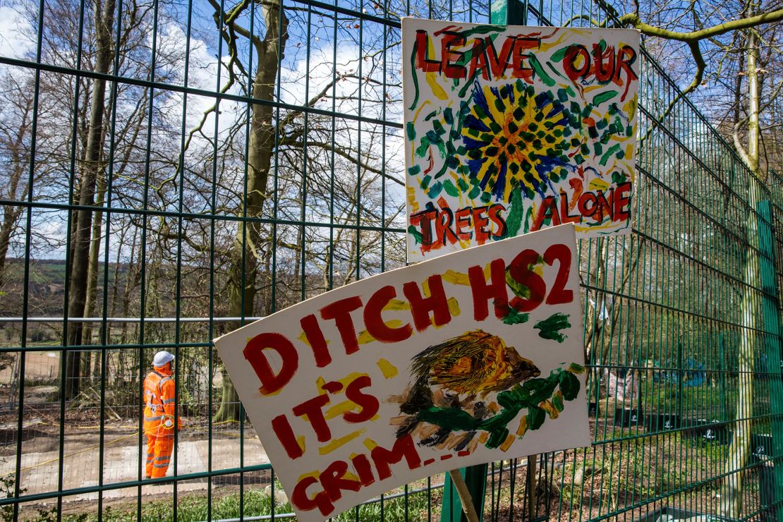 Signs placed on a fence by environmental activists protest against tree-felling operations for the HS2 rail link at Jones Hill Wood in Wendover, England, in April 2021.