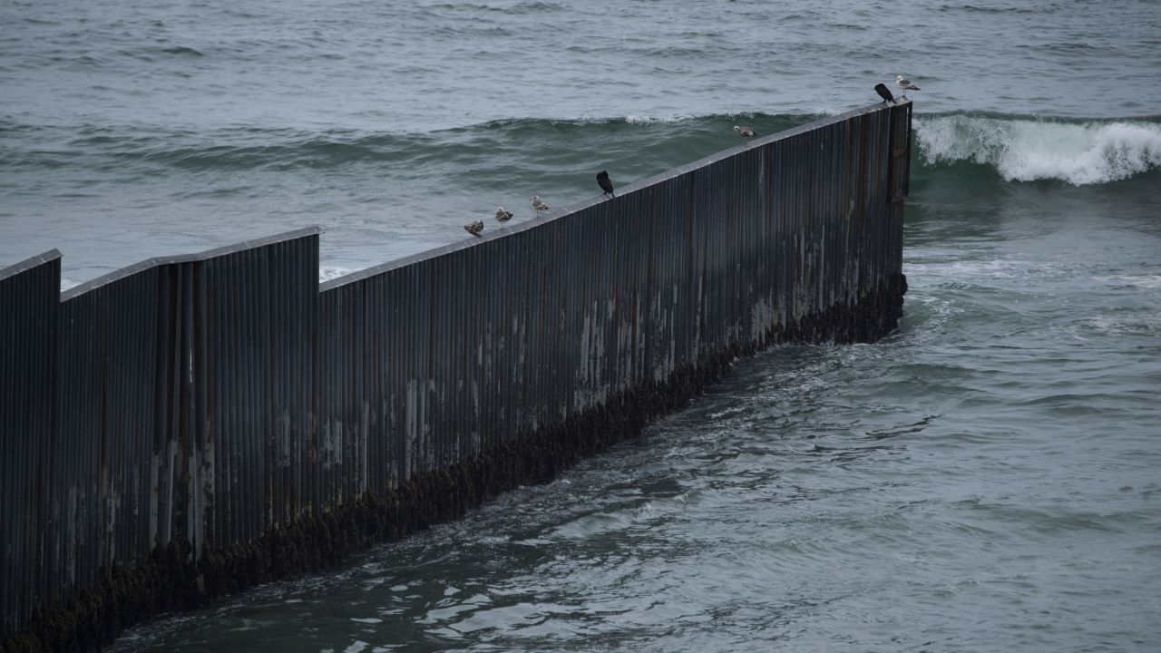 Birds stand on top of the border wall as it ends in the Pacific Ocean along the US-Mexico border between San Diego and Tijuana on May 10, 2021 at International Friendship Park in San Diego County, California. - Few issues have as long a history of bedeviling both Democrats and Republicans as immigration and asylum on the approximately 2,000-mile (3,000-kilometer) US-Mexico frontier. (Photo by Patrick T. FALLON / AFP) (Photo by PATRICK T. FALLON/AFP via Getty Images)