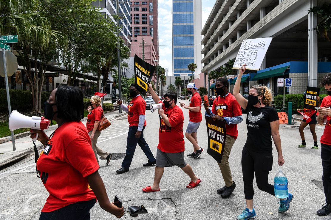 McDonald's employees march in the street to protest an increase in their minimum wage to $15 an hour in Fort Lauderdale, Florida, on May 19, 2021.