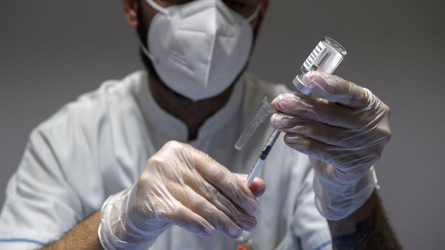A health care worker prepares doses of the AstraZeneca Covid-19 vaccine at a vaccine hub in the Auditorium della Tecnica in Rome in June 2021.