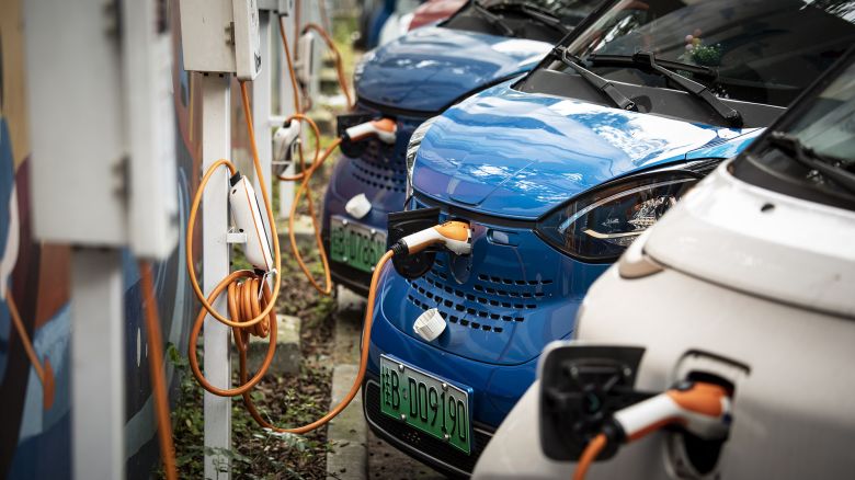 SAIC-GM-Wuling Automobile Co. electric vehicles are plugged in at charging stations at a roadside parking lot in Liuzhou, China, on Monday, May 17, 2021.