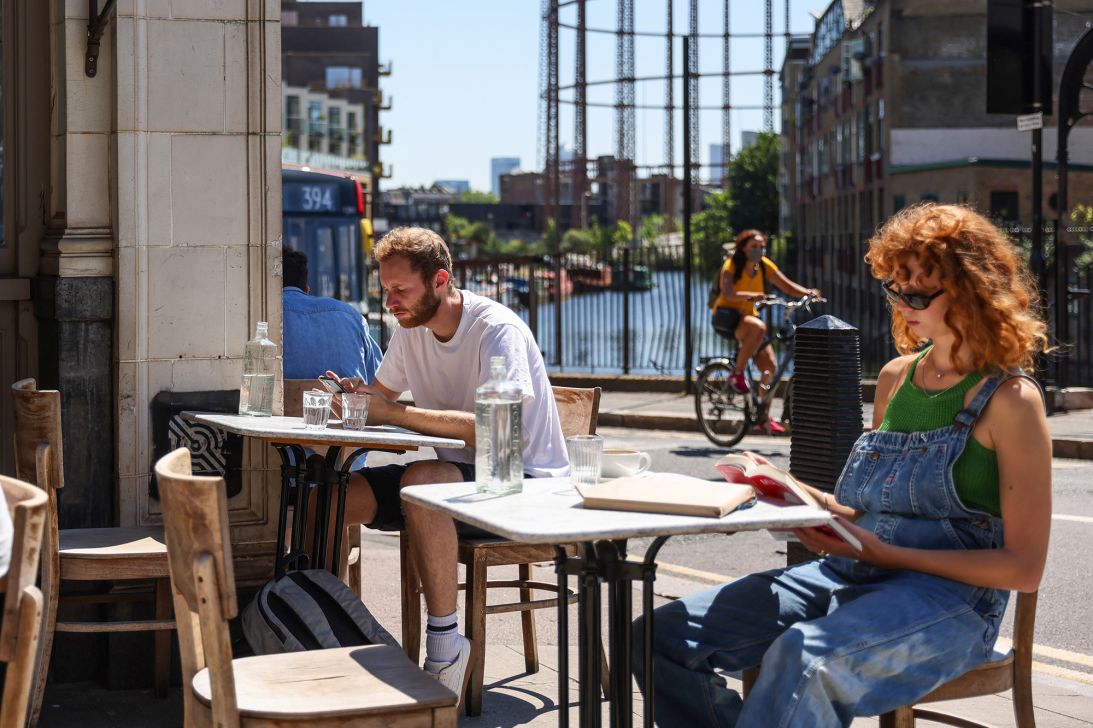 When you ask for a jug of tap water in the UK, it's rare that it'll come with ice, as demonstrated in this photo of people drinking water outdoors at Broadway Market in Hackney, London, U.K. in 2021.