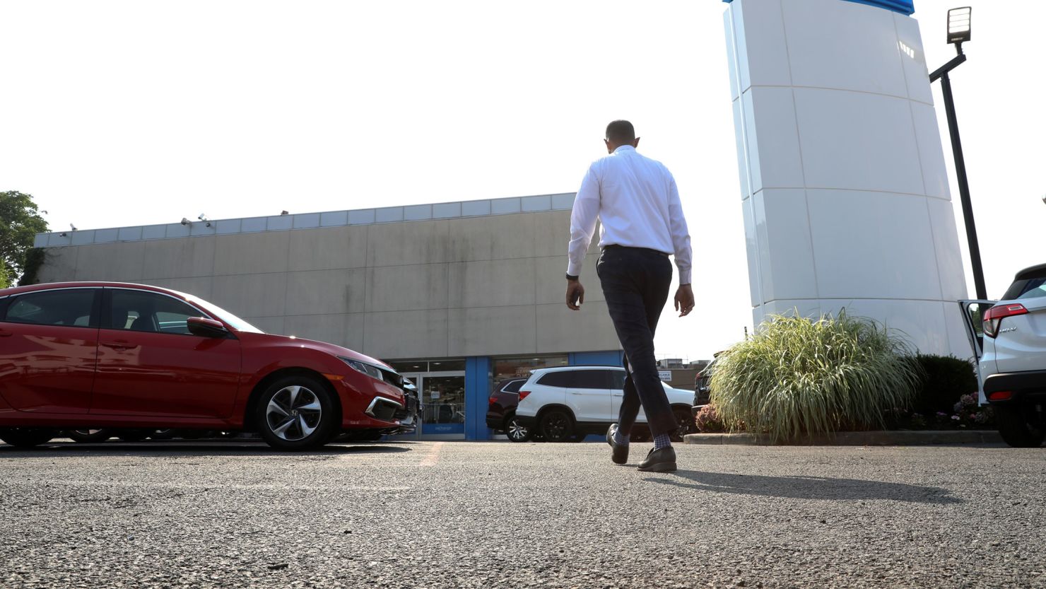 A worker walks through the lot of Paragon Honda and Acura car dealership in the Queens borough of New York on Thursday, July 15, 2021.