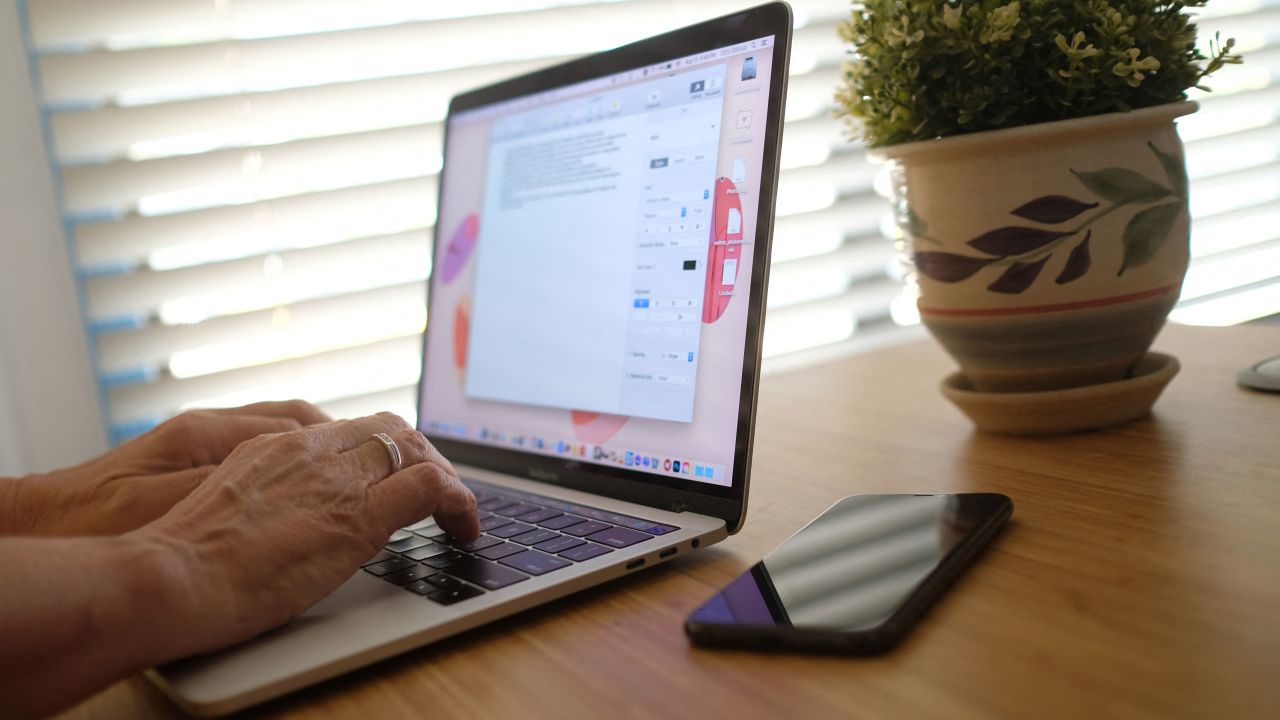 This illustration photo shows a person working on their laptop from a home office in Los Angeles on August 13, 2021. - In the United States, companies are delaying one after another the return of their employees to the office, worried about the new wave of contaminations with the spread of the Delta variant. (Photo by Chris DELMAS / AFP) (Photo by CHRIS DELMAS/AFP via Getty Images)