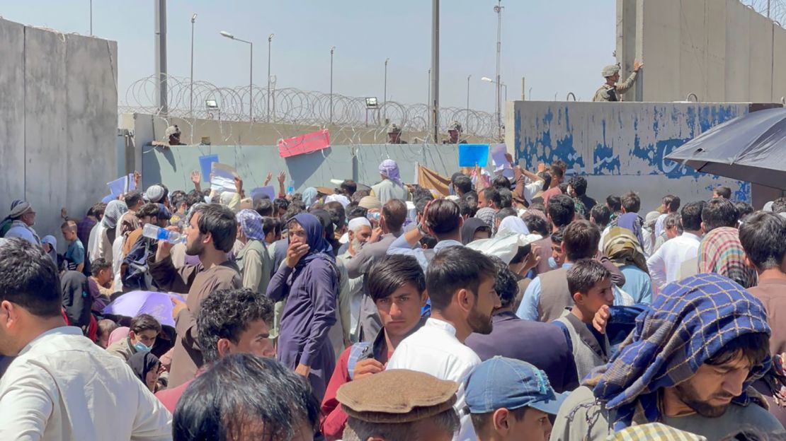 Afghan people hoping to leave the country wait outside Hamid Karzai International Airport in Kabul, Afghanistan, on August 26, 2021 – before the attack took place.