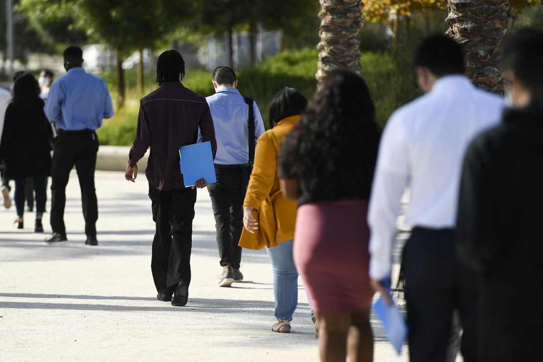 People wait in line to attend a job fair for employment with SoFi Stadium and Los Angeles International Airport employers, at SoFi Stadium on September 9, 2021, in Inglewood, California.