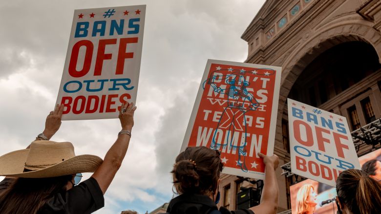 Demonstrators hold signs outside the Texas State Capitol during a Women's March in Austin, Texas, U.S., on Saturday, Oct. 2, 2021. Women's March and more than 90 other organizations organized a national rally to protect women's reproductive rights ahead of the Supreme Court reconvening on October 4.