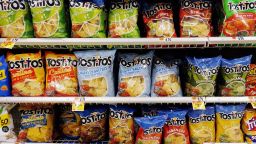 Bags of Tostitos tortilla chips are on display on a supermarket shelf on October 15, 2021, in Arlington, Virginia.
