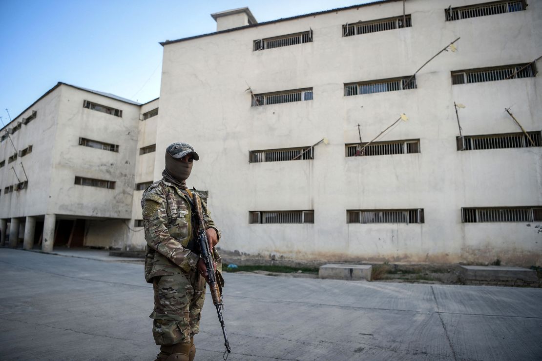 A guard stands by buildings at Pul-e-Charkhi prison, on the outskirts of Kabul, on October 17, 2021.