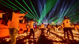 People watch a laser show on the banks of the river Sarayu during Deepotsav celebrations on the eve of the Hindu festival of Diwali in Ayodhya on November 3, 2021. (Photo by SANJAY KANOJIA / AFP) (Photo by SANJAY KANOJIA/AFP via Getty Images)