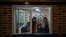 This picture taken on November 28, 2021 shows teachers and students attending a class on-air at Radio Begum in Kabul.