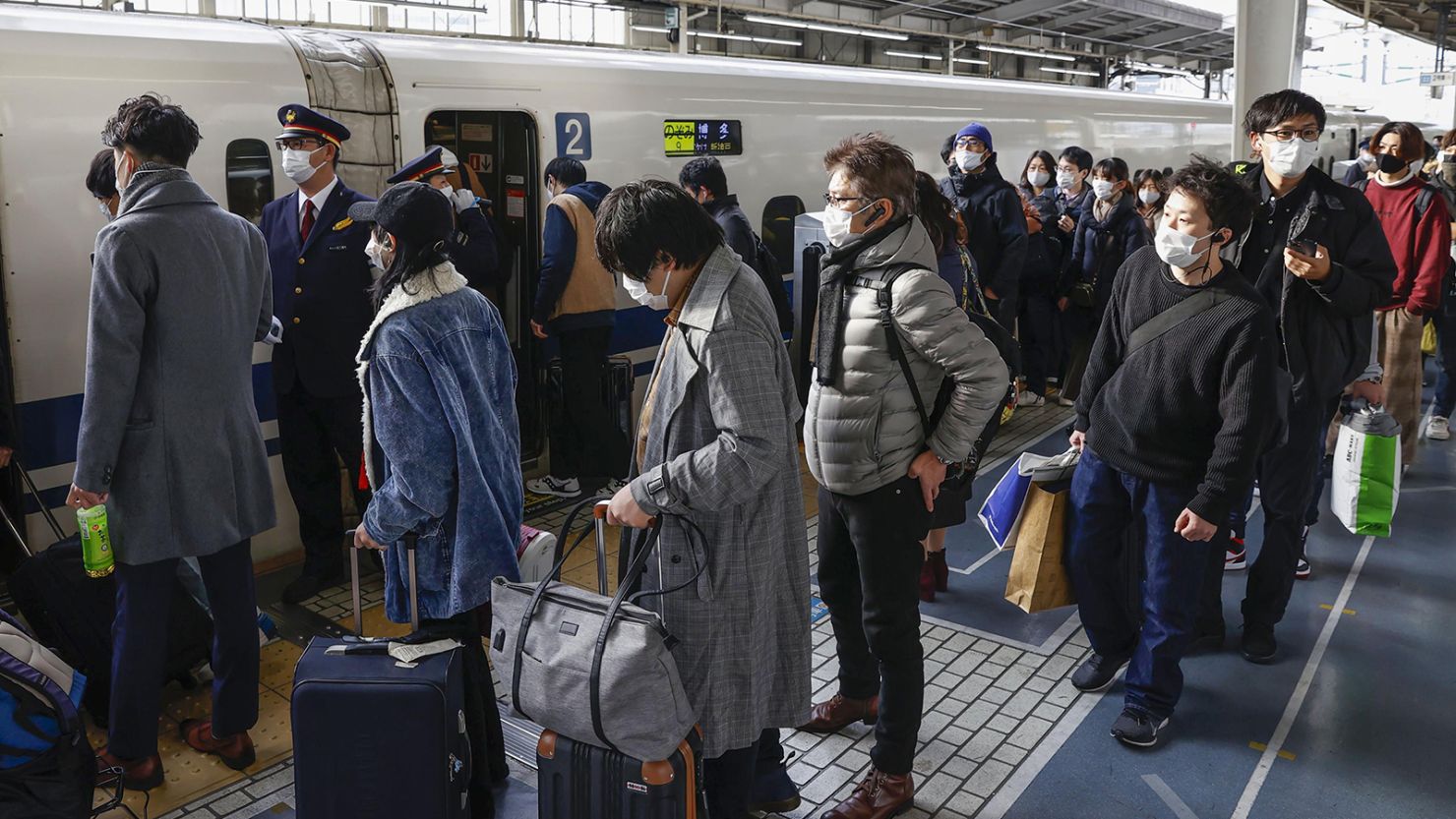 Passengers line up at a Shinkansen platform at JR Shin-Osaka Station on December 29, 2021.
