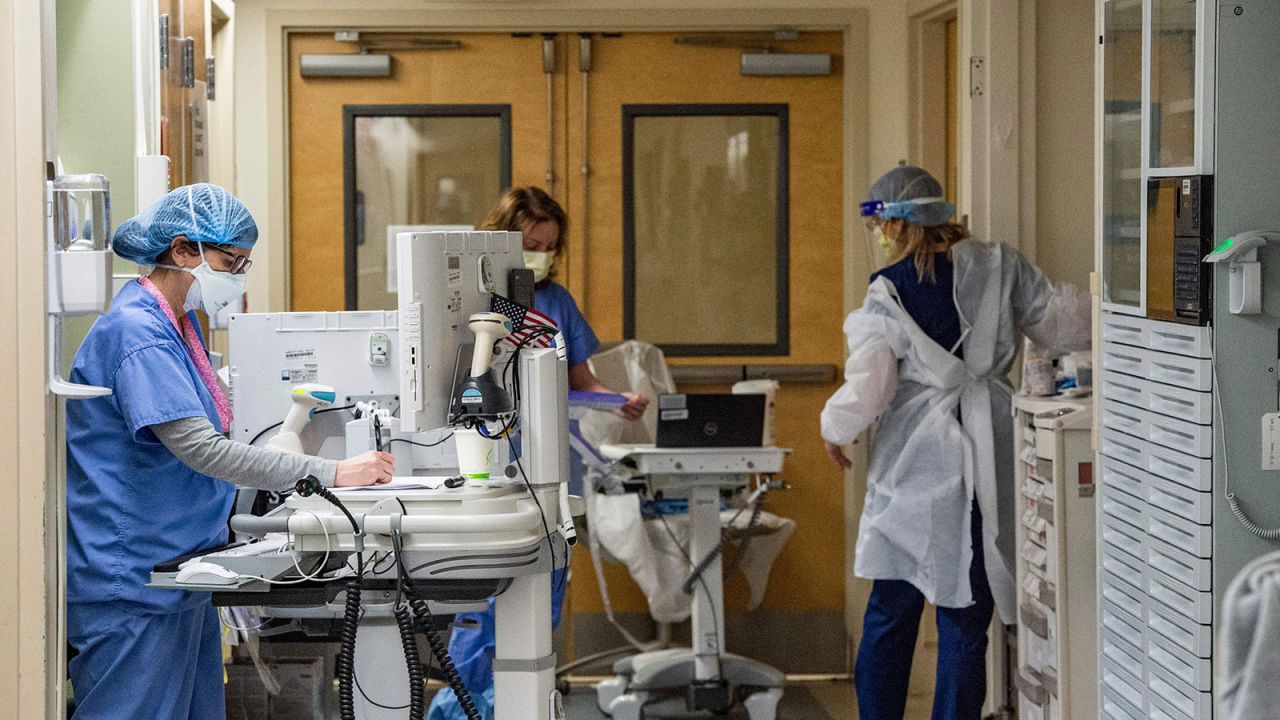 Medical workers treat patients in the Covid-19 ward at the US Department of Veterans Affairs Boston Healthcare system campus and medical center in West Roxbury, Massachusetts on January 11, 2022.