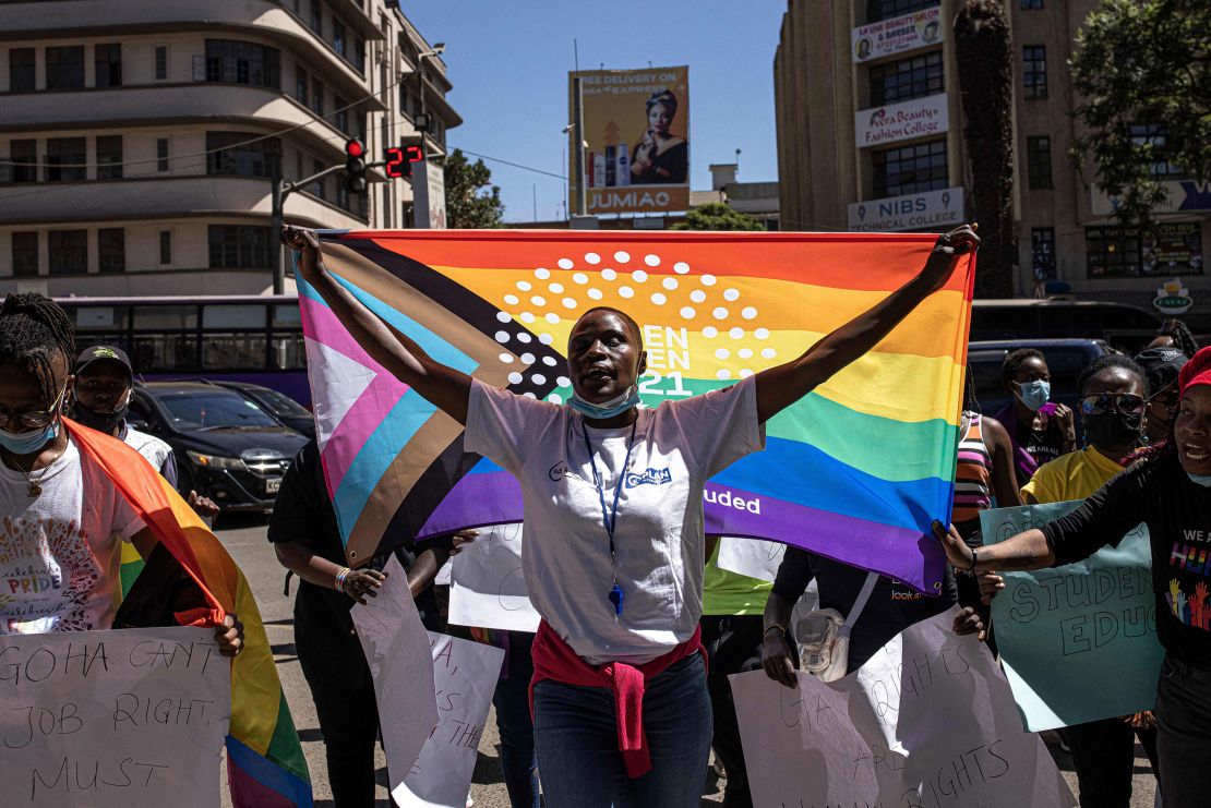 A woman holds a pride flag during a protest organized by The Queer Republic in Nairobi in January 2022.