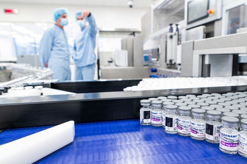 Employees work at the assembly line of the manufacturing facility of pharmaceutical company AstraZeneca in Sweden in 2022.