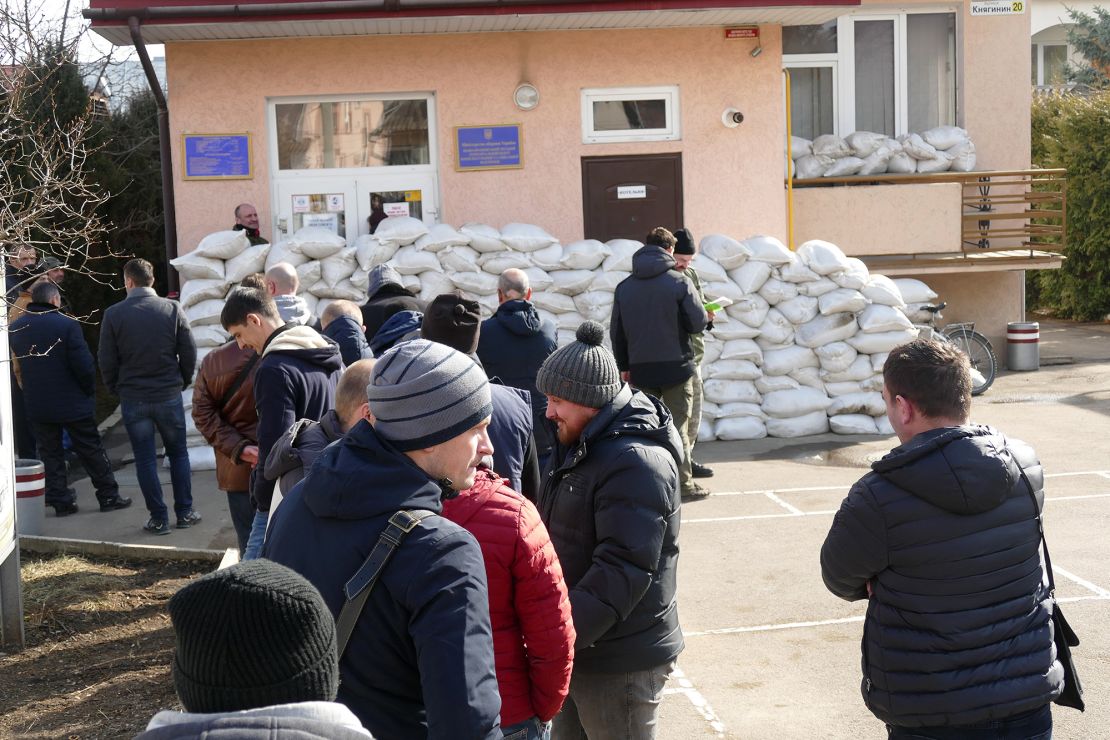 Volunteers, pictured on February 25, 2022, queue up outside the city's military registration and enlistment office to join the Territorial Defense Force, Ivano-Frankivsk, western Ukraine.