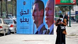 TOPSHOT - A banner depicting Syrian President Bashar al-Assad and Russian President Vladimir Putin and reading "Justice Prevails", is displayed along a highway in the Syrian capital Damascus, on March 8, 2022. (Photo by LOUAI BESHARA / AFP) (Photo by LOUAI BESHARA/AFP via Getty Images)