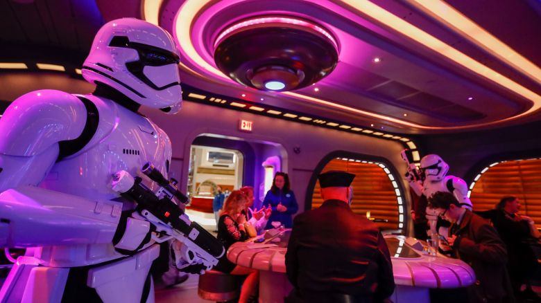 Orlando, Fla - March 01: First Order Stormtroopers patrol through the Sublight Lounge as the first passengers experience the two-day Walt Disney World  Star Wars Galactic Starcruiser, which is a live action role playing game that doubles as a high-end hotel in Orlando, Fla. The event is billed as Halcyons 275th anniversary voyage across the galaxy. at Walt Disney World  Star Wars Galactic Starcruiser in Orlando, Fla on Tuesday, March 1, 2022. First Order lieutenant Harman Croy and his garrison of stormtroopers patrol the ship. Guests arrive at Batuu, a destination for a planet excursion. Players use a data pad to play the immersive game while they participate in activities such as light saber training. (Allen J. Schaben / Los Angeles Times via Getty Images)