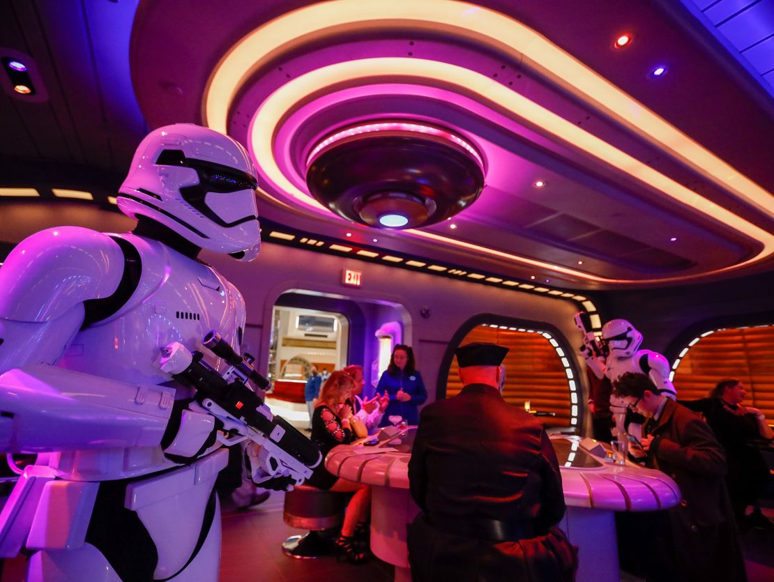 A stormtrooper walks through the crowd at Star Wars: Galactic Cruiser.