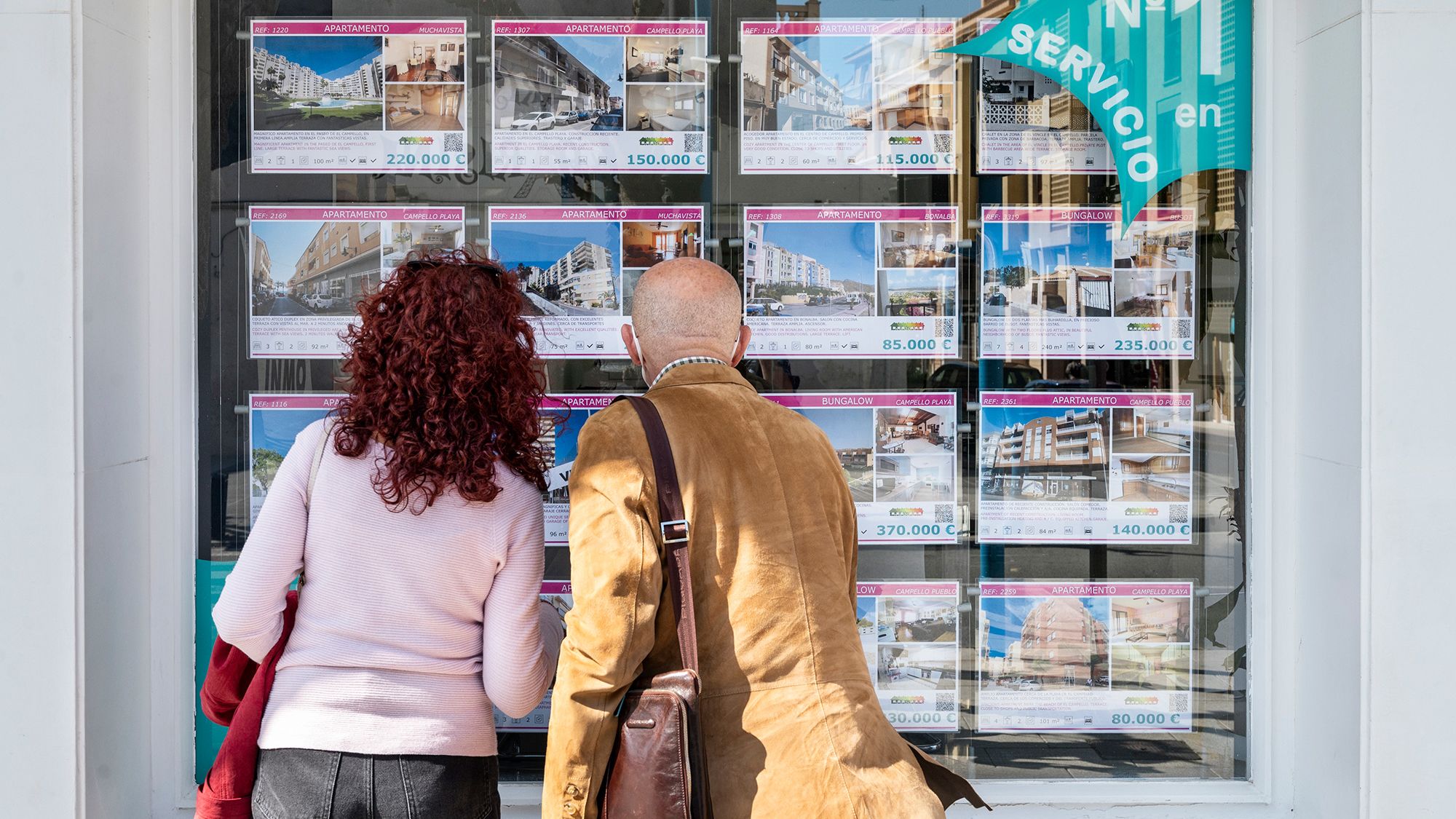 A couple looks at houses for sale and rent in Alicante, Spain, in March 2022.