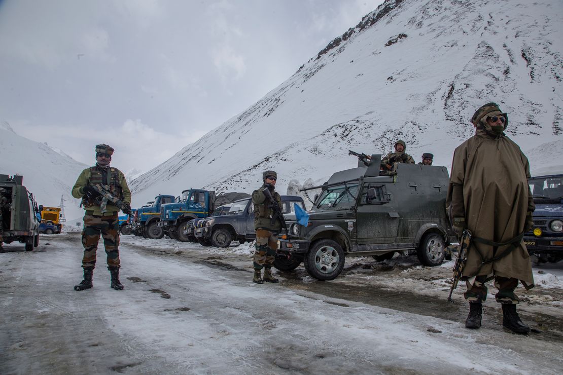 Indian soldiers stand guard along a highway in Ladakh in 2022.