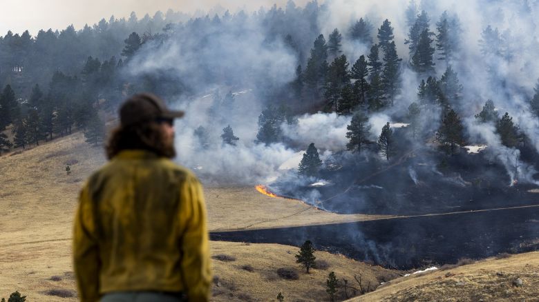 BOULDER, CO - MARCH 26: A firefighter watches as the NCAR Fire burns on March 26, 2022 in Boulder, Colorado. The wildfire, which has forced almost 20,000 people to evacuate their homes, started just a few miles away from where the Marshall Fire destroyed more than 1,000 homes in December, 2021. (Photo by Michael Ciaglo/Getty Images)