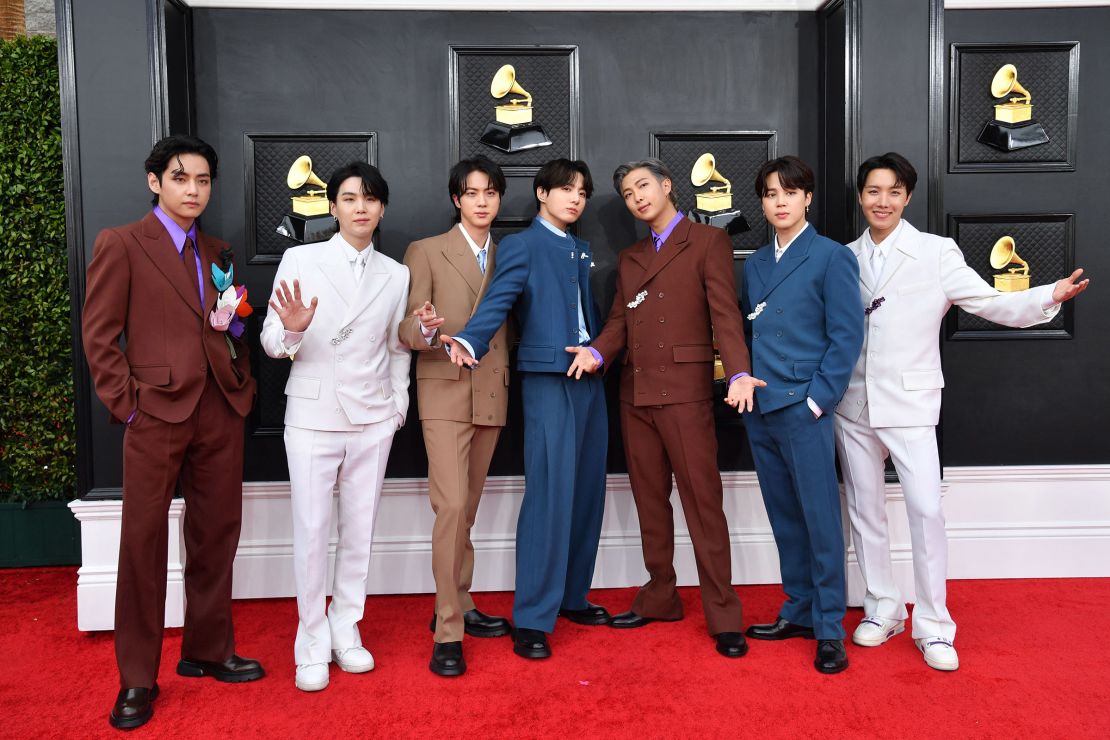 Fashion icons, the members of BTS wore color-coordinated Louis Vuitton suits in wool and cashmere with floral pins to the 64th Annual Grammy Awards on April 3, 2022.