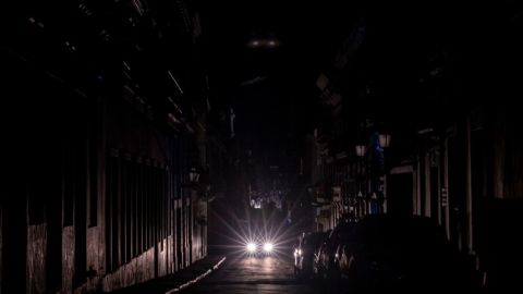 A motorist drives at night on a street without lights in San Juan, Puerto Rico after a major power outage hit the island on April 6, 2022. (Photo by Ricardo ARDUENGO / AFP) (Photo by RICARDO ARDUENGO/AFP via Getty Images)